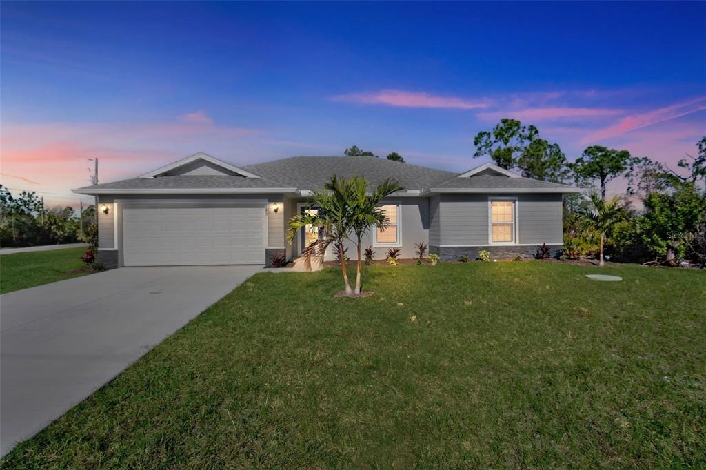 6193 Cabal Lane Port Charlotte, FL 33981 - Photo 1 of 28 a front view of a house with a garden