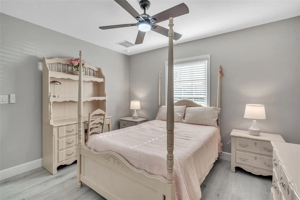 6193 Cabal Lane Port Charlotte, FL 33981 - Photo 13 of 28 a bedroom with a bed and a chandelier