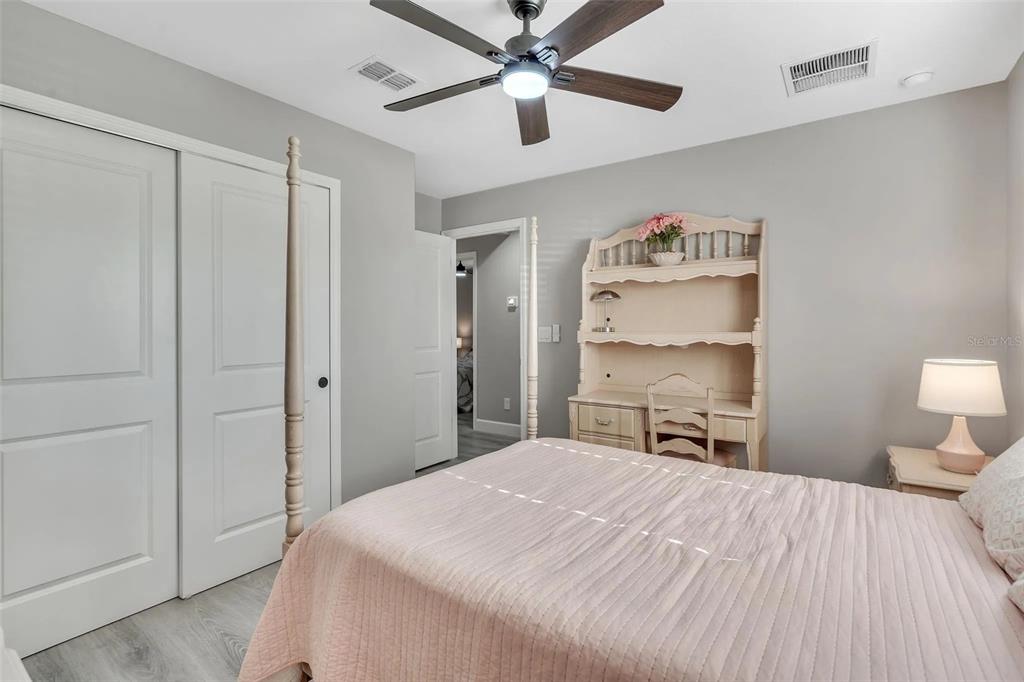 6193 Cabal Lane Port Charlotte, FL 33981 - Photo 14 of 28 a bedroom with a bed and a chandelier