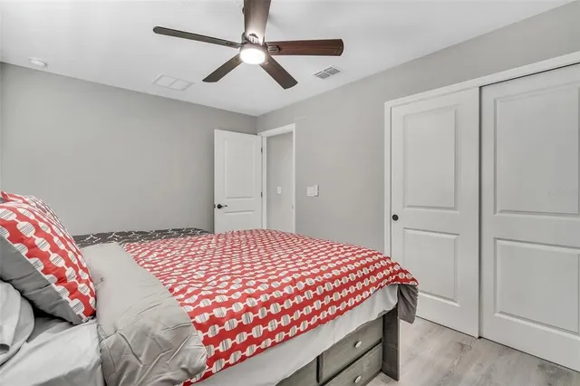 a bedroom with a bed and a chandelier