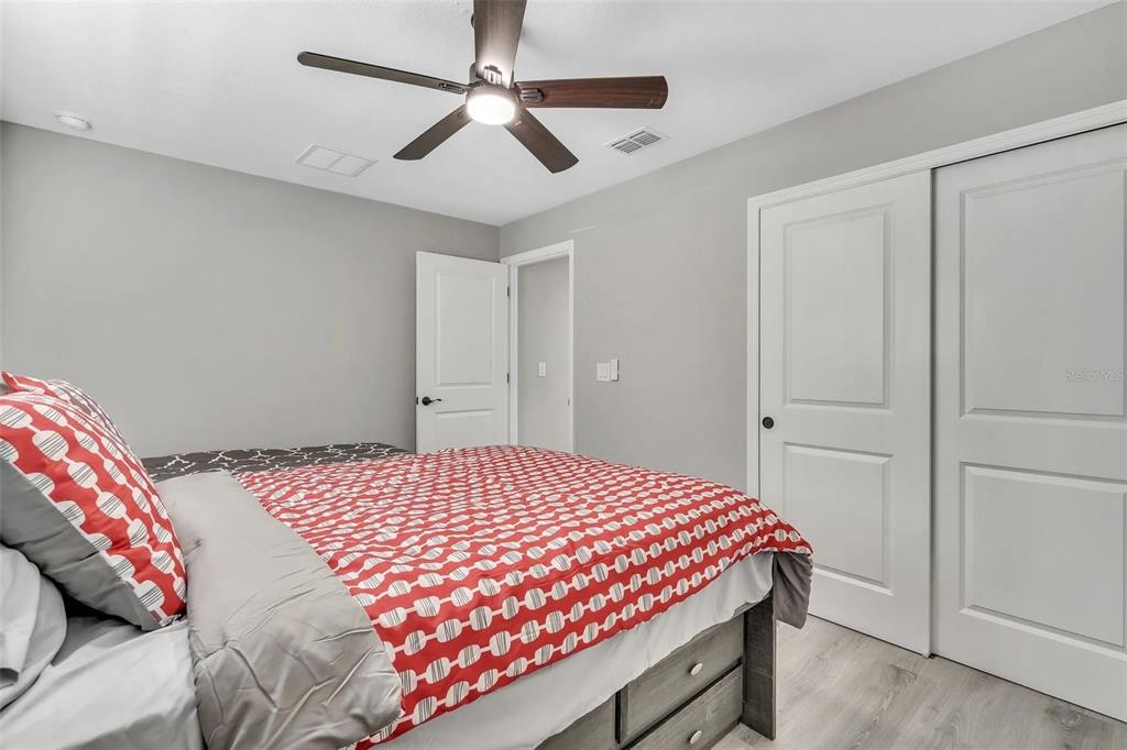 6193 Cabal Lane Port Charlotte, FL 33981 - Photo 17 of 28 a bedroom with a bed and a chandelier