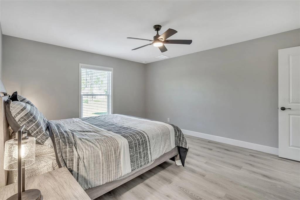 6193 Cabal Lane Port Charlotte, FL 33981 - Photo 18 of 28 a bedroom with a bed and window