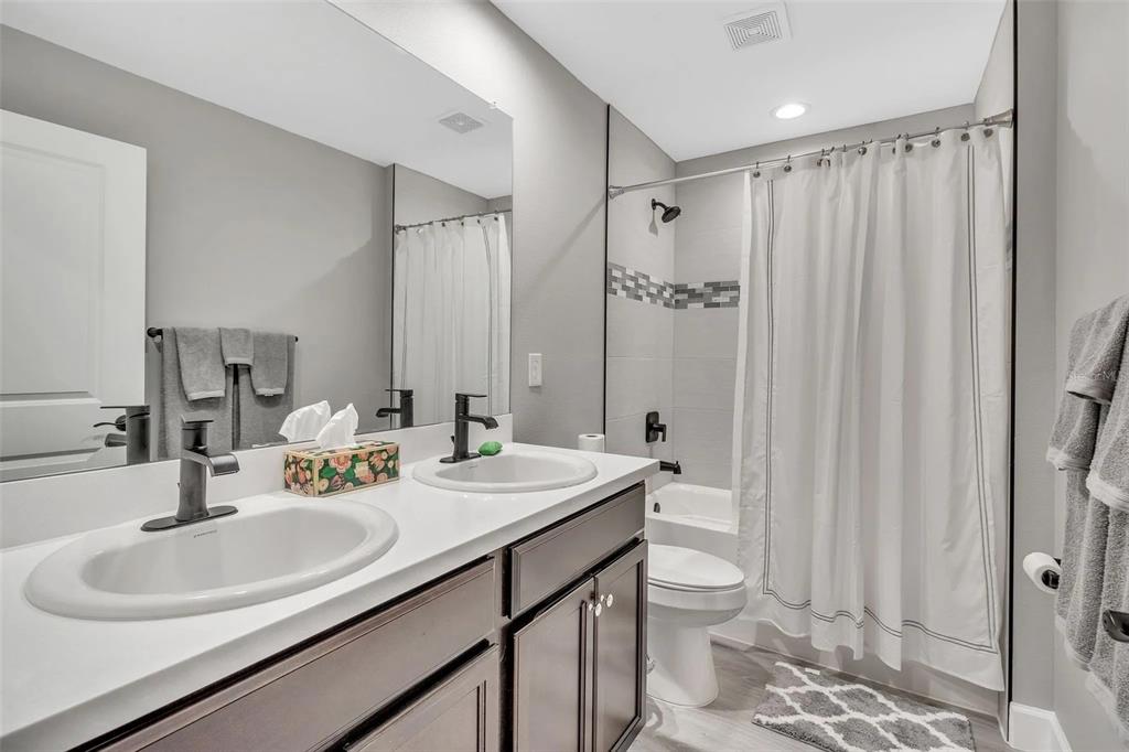 6193 Cabal Lane Port Charlotte, FL 33981 - Photo 22 of 28 a bathroom with a double vanity sink toilet and a mirror