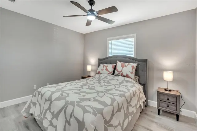 a bedroom with a bed and a chandelier