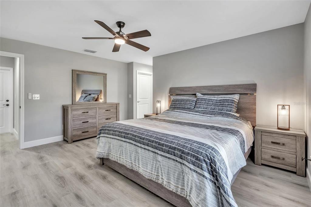 6193 Cabal Lane Port Charlotte, FL 33981 - Photo 3 of 28 a bedroom with a bed and a chandelier