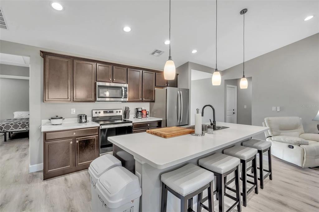 6193 Cabal Lane Port Charlotte, FL 33981 - Photo 4 of 28 a kitchen with a dining table chairs sink and cabinets