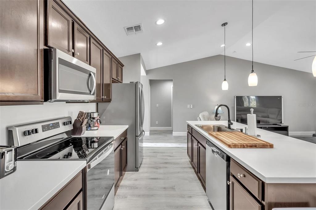 6193 Cabal Lane Port Charlotte, FL 33981 - Photo 7 of 28 a kitchen with stainless steel appliances granite countertop a sink stove and refrigerator
