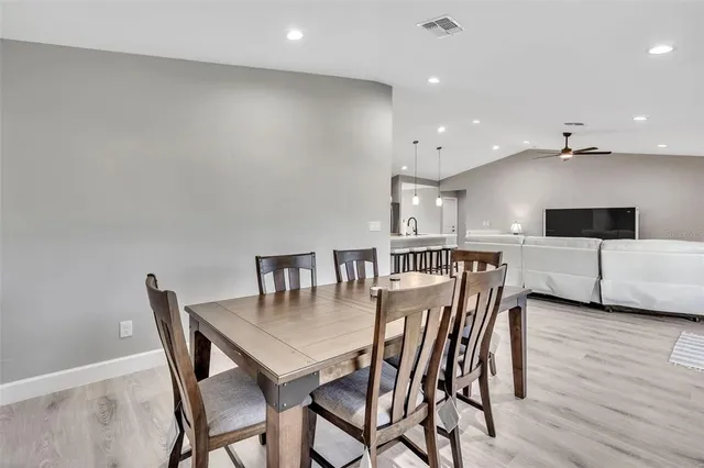 a view of a dining room with furniture and wooden floor