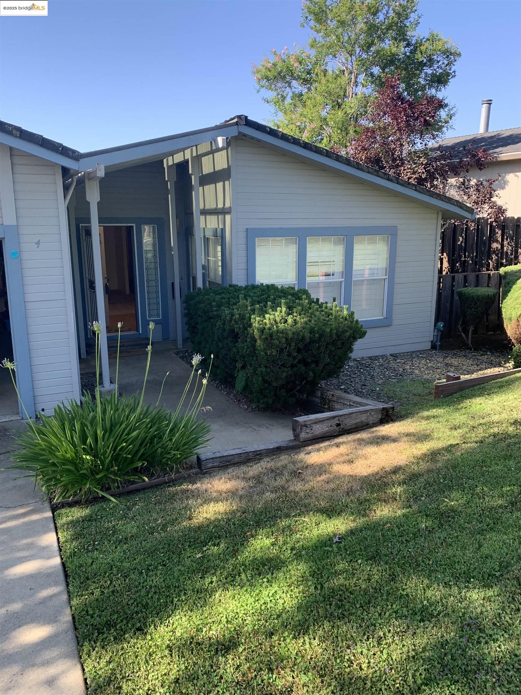 12800 Honey Locust Court, Unit 4 Sonora, CA 95370 - Photo 1 of 13 a front view of a house with a yard