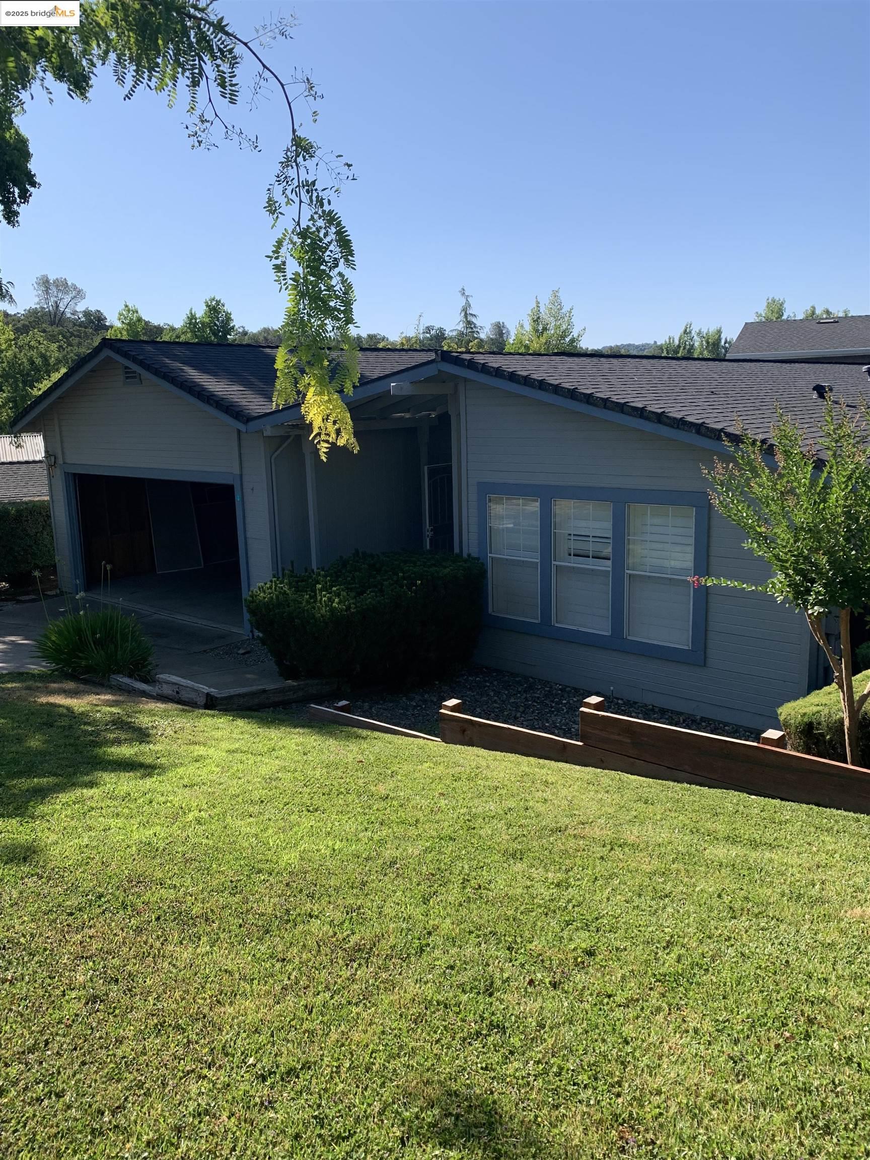 12800 Honey Locust Court, Unit 4 Sonora, CA 95370 - Photo 2 of 13 a house view with a garden space