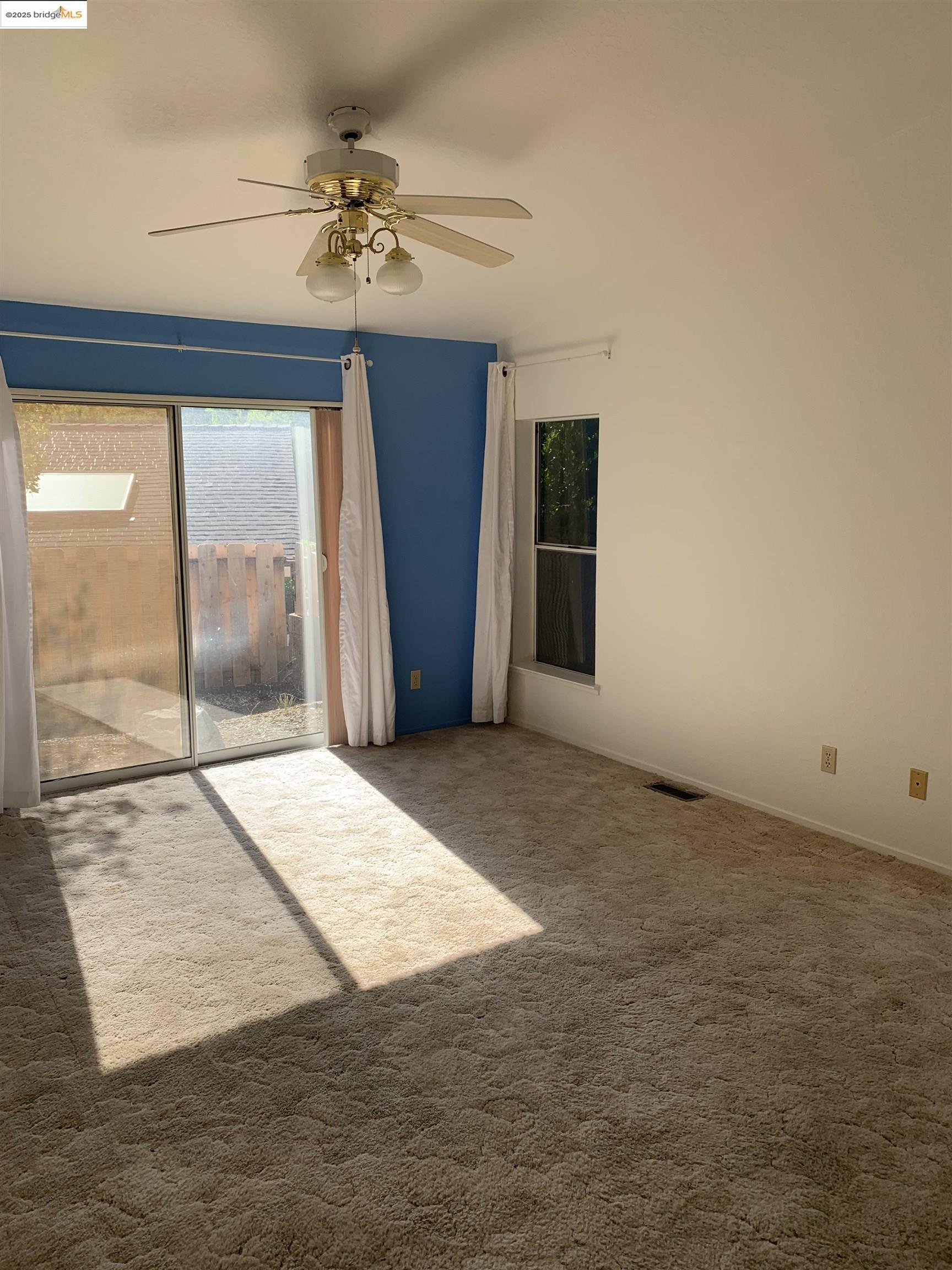12800 Honey Locust Court, Unit 4 Sonora, CA 95370 - Photo 5 of 13 an empty room with fan and windows