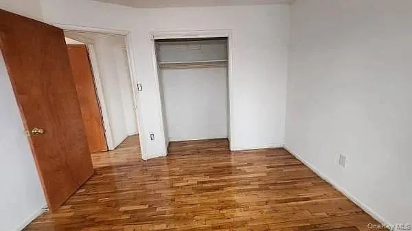 a view of an empty room with wooden door