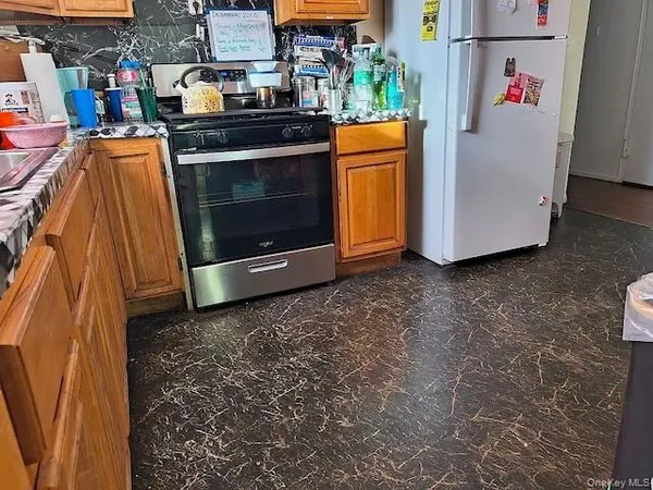 a stove top oven sitting inside of a kitchen