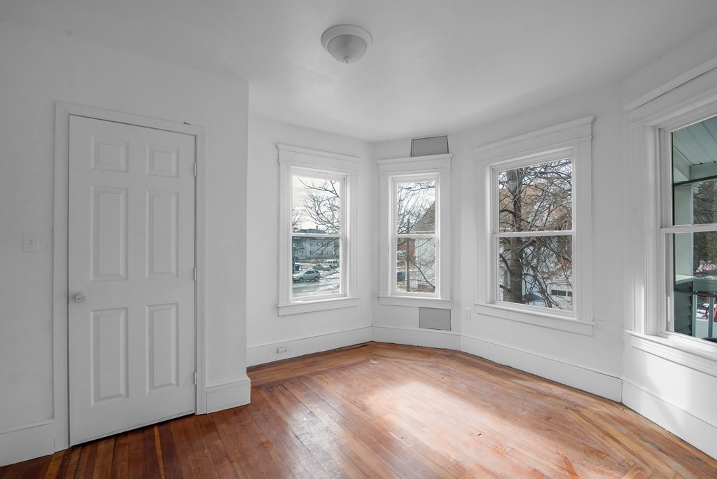 131 Ranney Street Springfield, MA 01108 - Photo 5 of 25 a view of an empty room with window and wooden floor
