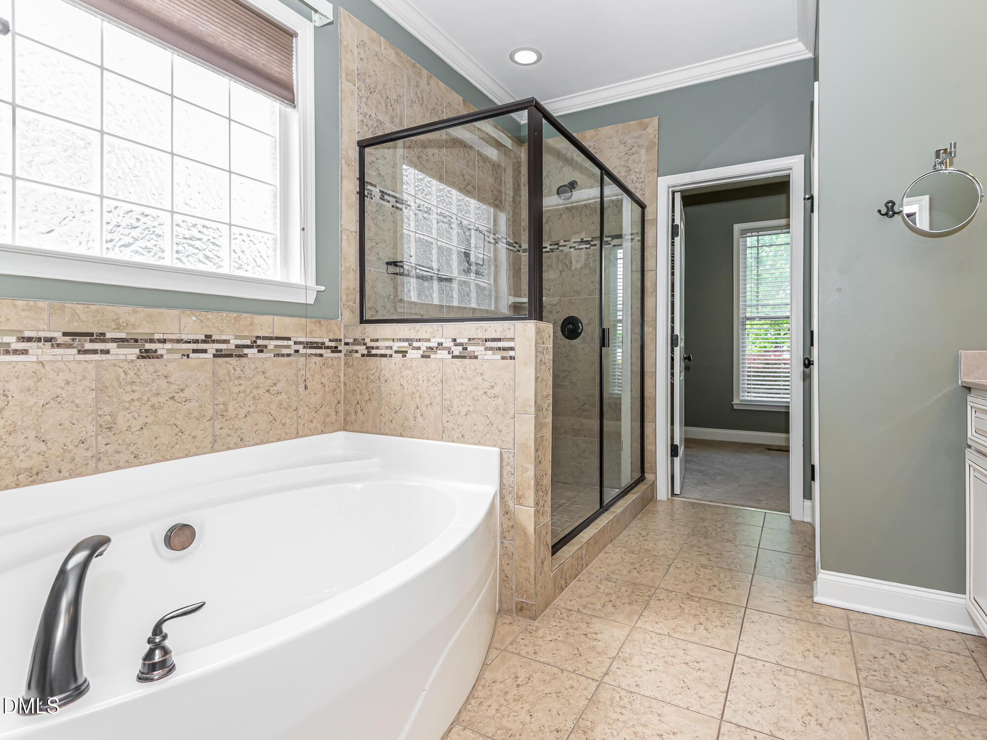 337 Shadowdale Lane Rolesville, NC 27571 - Photo 20 of 42 a bathroom with a tub a sink and a window