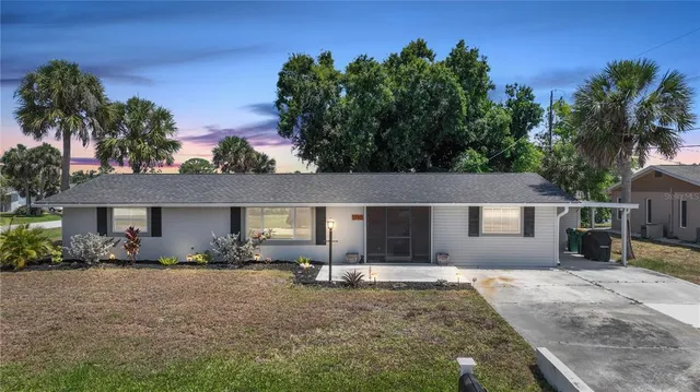 a front view of a house with a yard and a garage