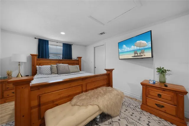 a bedroom with furniture and paintings on the wall