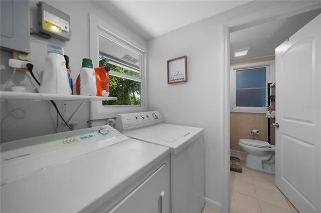 a bathroom with a granite countertop sink vanity mirror and toilet