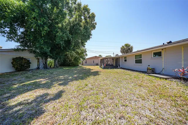 an aerial view of a house with a garden and lake view