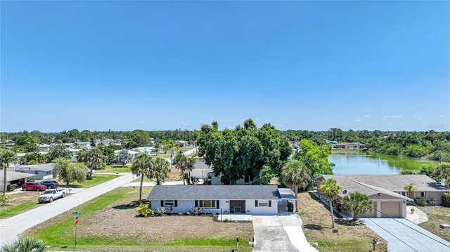 an aerial view of a house with swimming pool garden and patio