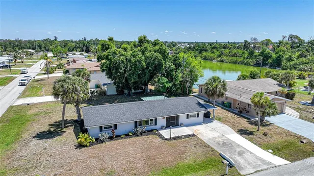 an aerial view of house with yard swimming pool and outdoor seating