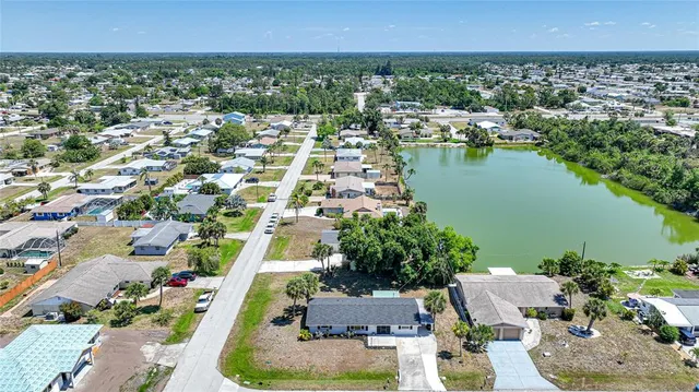 an aerial view of a house with a lake view