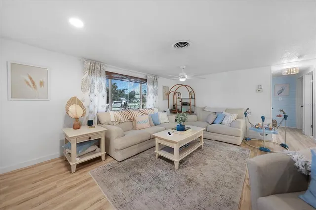 a living room with furniture a rug and a large window