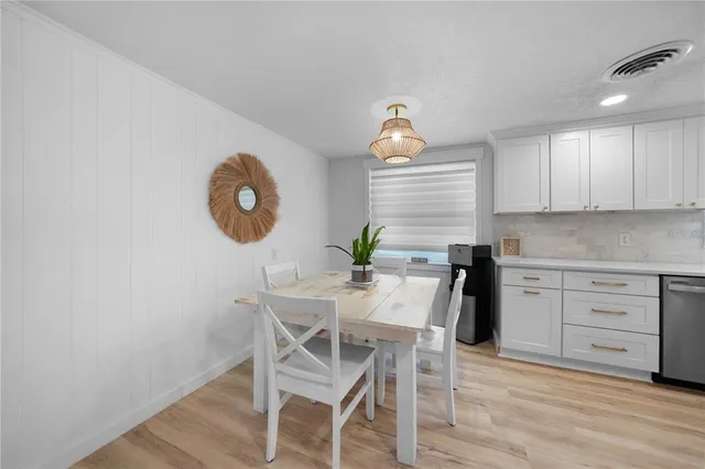 a view of a kitchen with a table and chairs