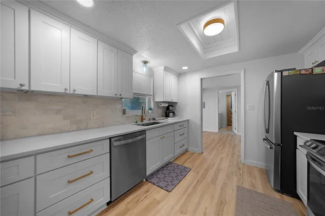 a kitchen with cabinets appliances and a counter space