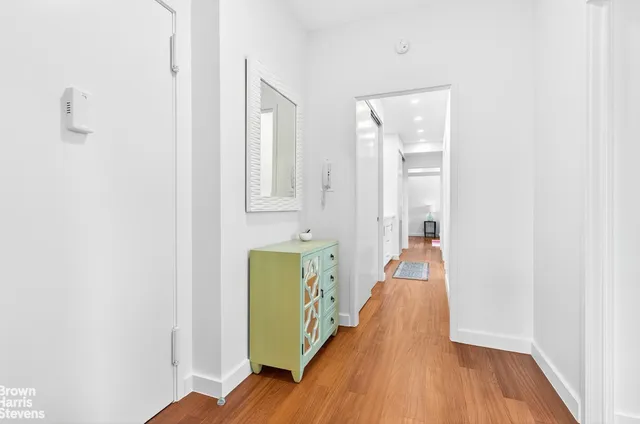 a kitchen with a refrigerator sink and cabinets