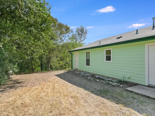 a view of a backyard with a tree
