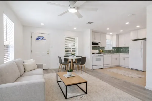 a living room with furniture and kitchen view