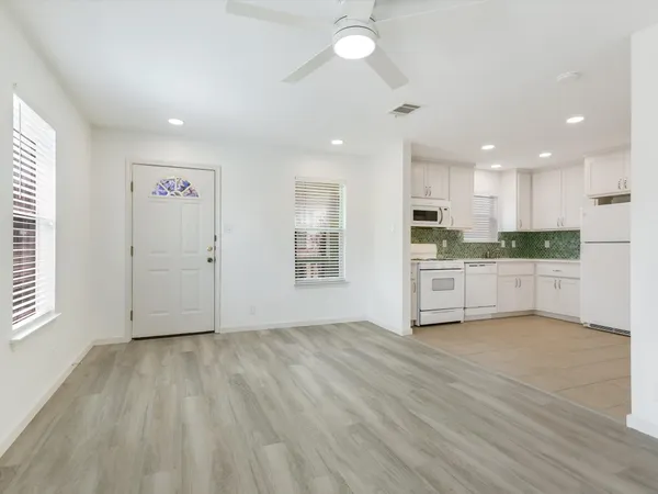 a view of kitchen with wooden floor and electronic appliances