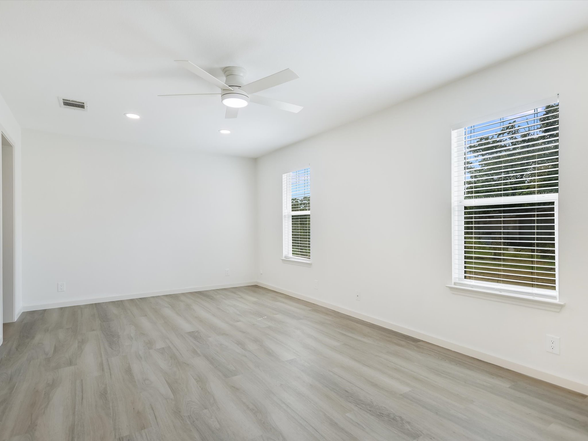 5104 Delores Avenue, Unit B Austin, TX 78721 - Photo 6 of 12 a view of an empty room with wooden floor and a window