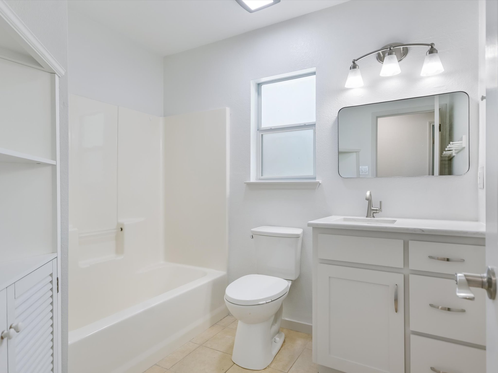 5104 Delores Avenue, Unit B Austin, TX 78721 - Photo 8 of 12 a bathroom with a toilet sink and mirror