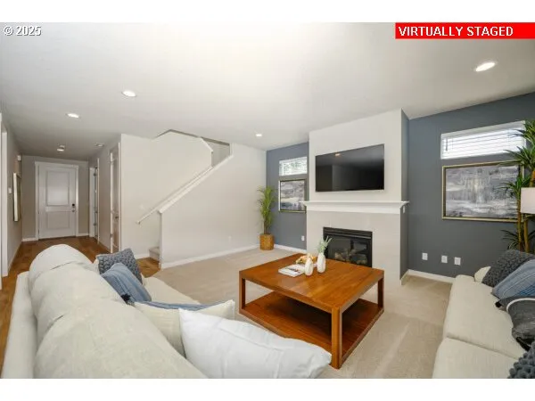 a living room with furniture a flat screen tv and a fireplace