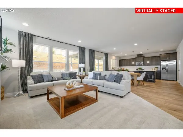 a living room with furniture kitchen and a table