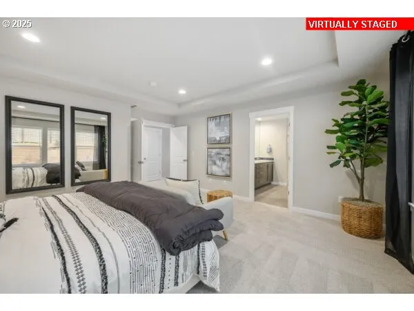 a spacious bedroom with a large bed and a potted plant