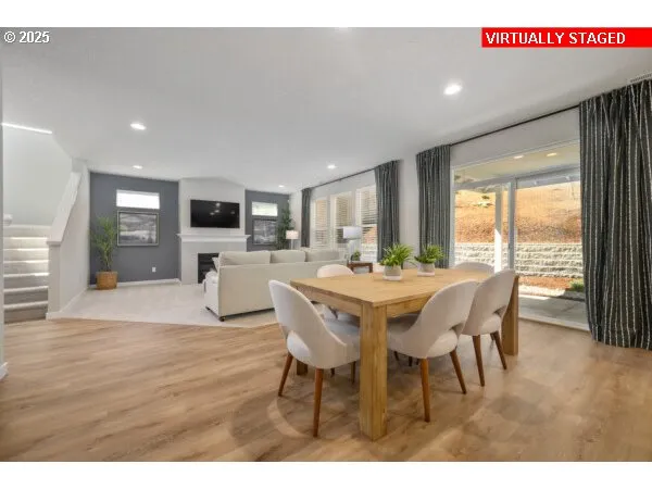 a dining room with furniture and wooden floor