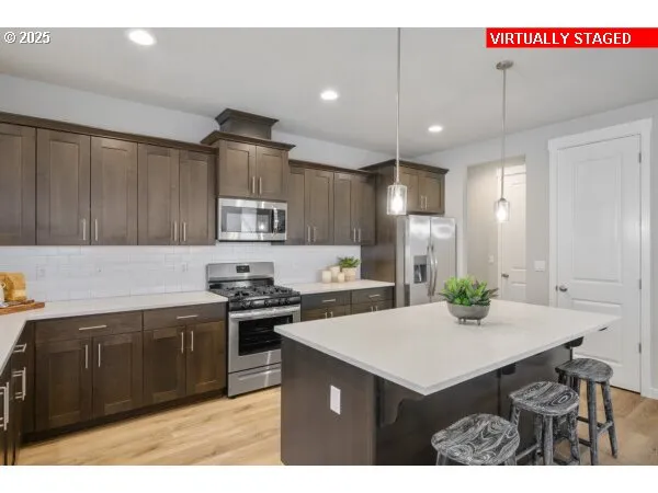 a kitchen with a stove a refrigerator and a sink