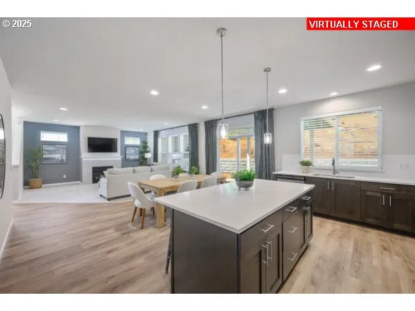 a kitchen with a table chairs and a wooden floor