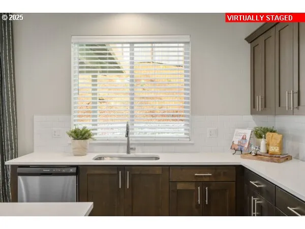 a kitchen with a sink a window and cabinets