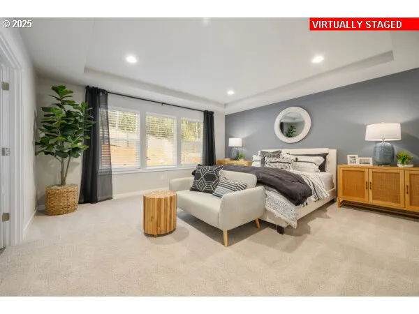 a bedroom with furniture and a large window