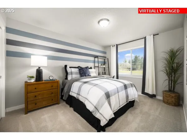 a spacious bedroom with a bed and a potted plant