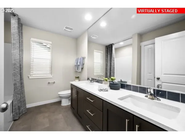 a bathroom with a double vanity sink and a mirror