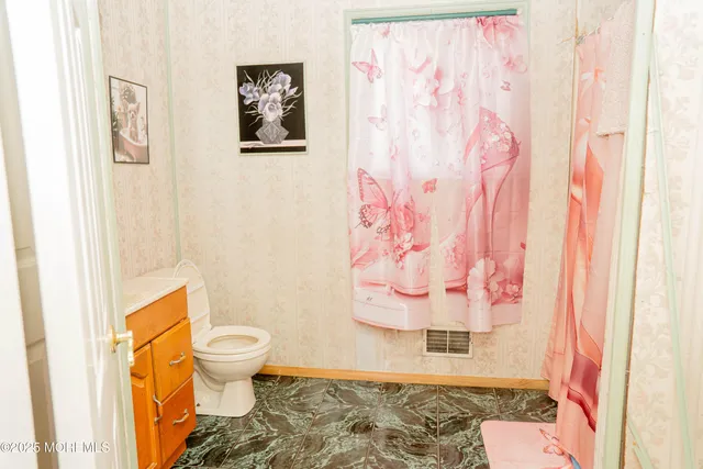 a bed with a white bed and a chair