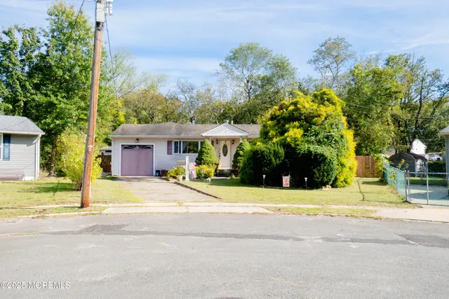 a yellow house with trees in front of it