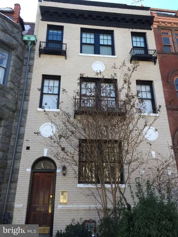 a front view of a house with parking space