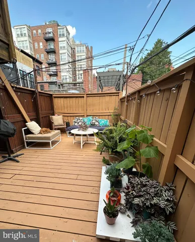 a view of a terrace with chairs and potted plants