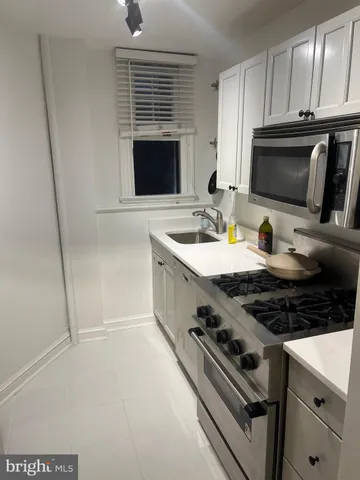 a kitchen with a stove a sink and a microwave
